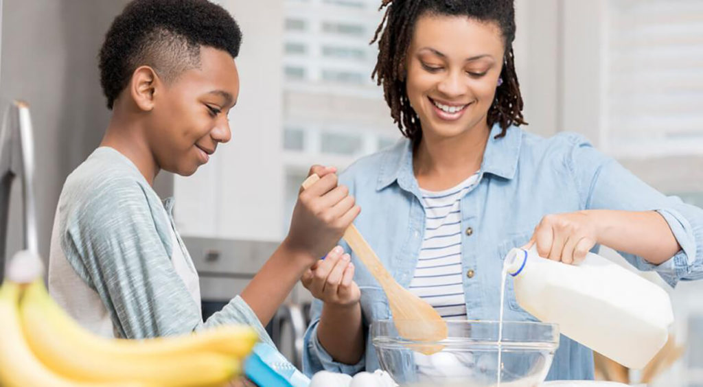Mother and son baking with milk